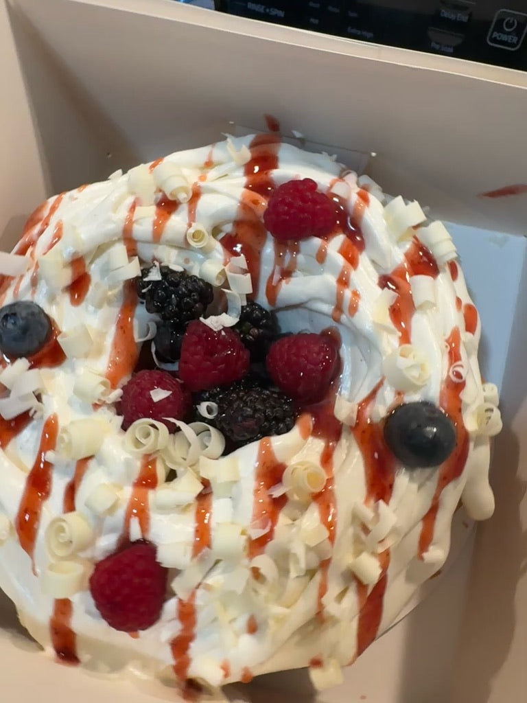 Berry bundt with cream, raspberries, blackberries and white chocolate curls